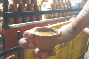 Experiencing Asian tea culture in a cup. Cutting Chai (half chai in quantity and price) on earthen cup sold on the roadside tea stall.